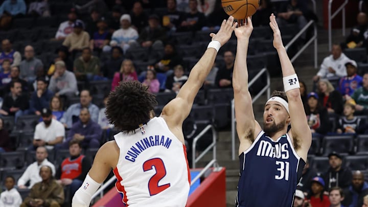 Jan 31, 2025; Detroit, Michigan, USA;  Dallas Mavericks guard Klay Thompson (31) shoots over Detroit Pistons guard Cade Cunningham (2) in the first half at Little Caesars Arena. Mandatory Credit: Rick Osentoski-Imagn Images