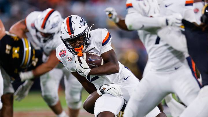 Virginia Cavaliers running back Xay Davis (25) drives up field during the second quarter of the TaxSlayer Gator Bowl at EverBank Stadium Saturday December 27, 2025 in Jacksonville, Fla. [Doug Engle/Florida Times-Union]