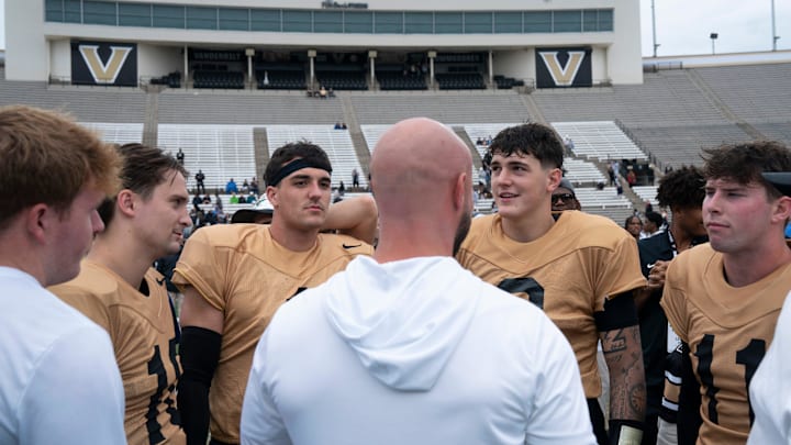 Vanderbilt quarterbacks, from left, Whit Muschamp (10), Blaze Berlowitz (1), Jared Curtis (2) and Jack Elliott (11) gather for a talk after Vanderbilt Football's Black and Gold Spring Game in FirstBank Stadium at Vanderbilt University Saturday, April 18, 2026.