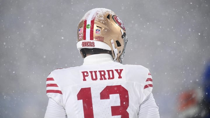 Dec 1, 2024; Orchard Park, New York, USA; Snow sits on top of the helmet of San Francisco 49ers quarterback Brock Purdy (13) in the fourth quarter game against the Buffalo Bills at Highmark Stadium. Mandatory Credit: Mark Konezny-Imagn Images