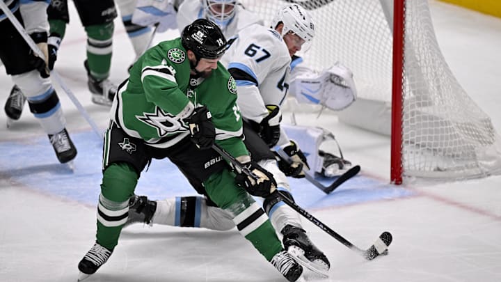 Mar 16, 2026; Dallas, Texas, USA; Dallas Stars left wing Jamie Benn (14) attempts to poke the puck past Utah Mammoth defenseman Nick DeSimone (57) during the second period at the American Airlines Center. Mandatory Credit: Jerome Miron-Imagn Images