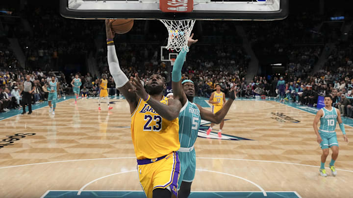 Jan 27, 2025; Charlotte, North Carolina, USA: Los Angeles Lakers forward LeBron James (23) goes up for a layup past Charlotte Hornets center Mark Williams (5) during the second half at the Spectrum Center. Mandatory Credit: Jim Dedmon-Imagn Images Jan 27, 2025; Charlotte, North Carolina, USA: Los Angeles Lakers forward LeBron James (23) goes up for a layup past Charlotte Hornets center Mark Williams (5) during the second half at the Spectrum Center. Mandatory Credit: Jim Dedmon-Imagn Images