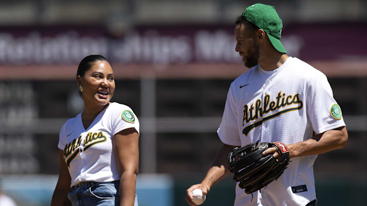 Golden State Warriors star Stephen Curry (right) and his wife Ayesha throw out the ceremonial first pitch before a game between the Oakland Athletics and Houston Astros game.