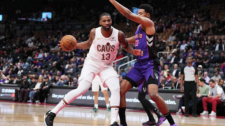 Oct 23, 2024; Toronto, Ontario, CAN; Cleveland Cavaliers center Tristan Thompson (13) controls the ball as Toronto Raptors center Ulrich Chomche (22) tries to defend during the fourth quarter at Scotiabank Arena. Mandatory Credit: Nick Turchiaro-Imagn Images