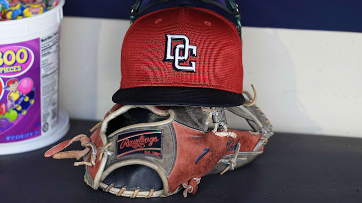 Jul 12, 2024; Milwaukee, Wisconsin, USA;  An Washington Nationals hat and glove sit in the dugout during batting practice prior to the game against the Milwaukee Brewers at American Family Field. Mandatory Credit: Jeff Hanisch-Imagn Images