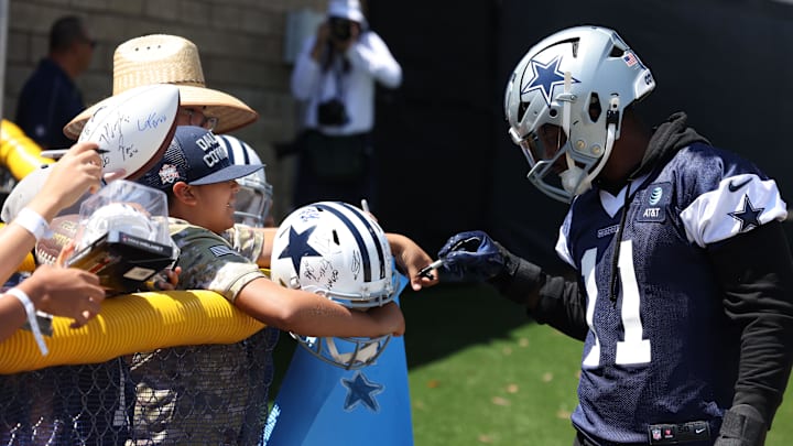 Dallas Cowboys linebacker Micah Parsons signs autographs during training camp.