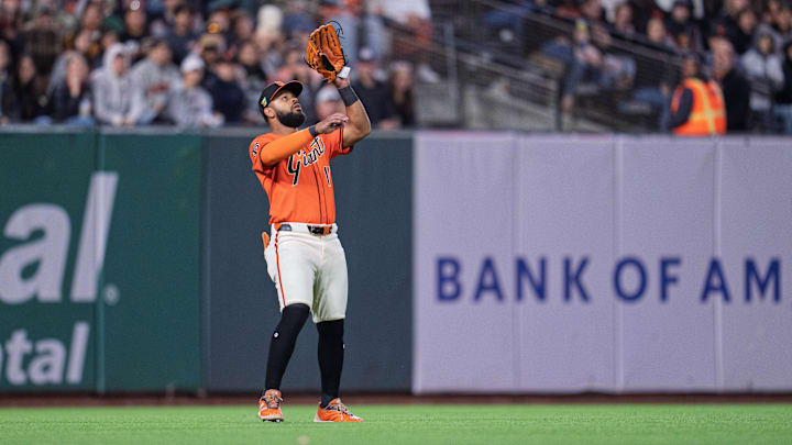 Aug 15, 2025; San Francisco, California, USA; San Francisco Giants left fielder Heliot Ramos (17) fields a fly ball against the Tampa Bay Rays during the sixth inning at Oracle Park. Mandatory Credit: Neville E. Guard-Imagn Images