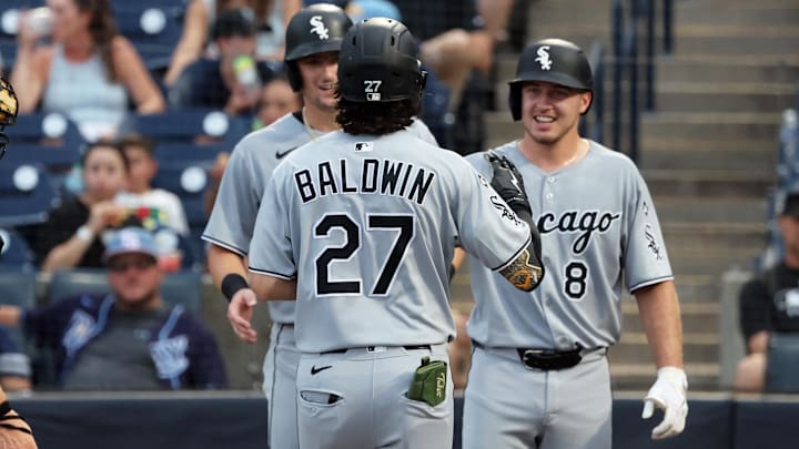 Chicago White Sox left fielder Brooks Baldwin (27) celebrates with shortstop Colson Montgomery (12) and catcher Kyle Teel (8) after hitting a three-run home run against the Tampa Bay Rays at George M. Steinbrenner Field. 