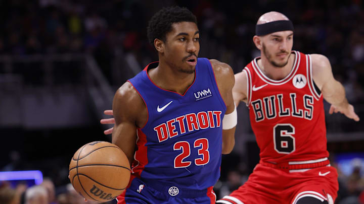 Apr 11, 2024; Detroit, Michigan, USA;  Detroit Pistons guard Jaden Ivey (23) dribbles on Chicago Bulls guard Alex Caruso (6) in the first half at Little Caesars Arena. Mandatory Credit: Rick Osentoski-Imagn Images