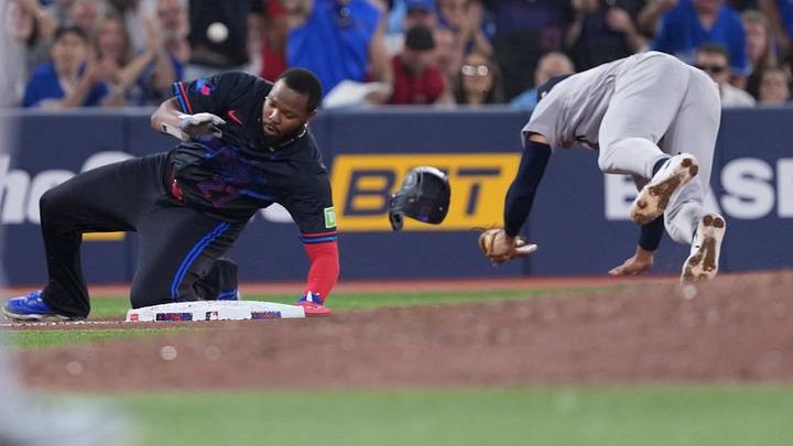Aug 14, 2026; Toronto, Ontario, CAN; Toronto Blue Jays first baseman Vladimir Guerrero Jr. runs into New York Yankees shortstop George Lombard Jr. (96) during the sixth inning at Rogers Centre. Mandatory Credit: Nick Turchiaro-Imagn Images