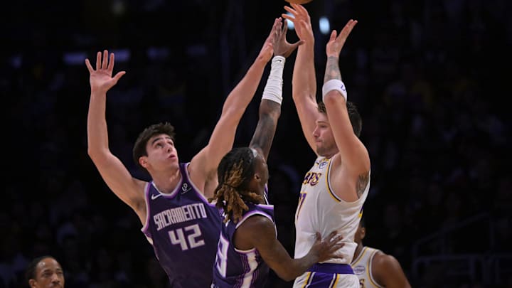 Dec 28, 2025; Los Angeles, California, USA; Sacramento Kings center Maxime Raynaud (42) and guard Keon Ellis (23) defend Los Angeles Lakers guard Luka Doncic (77) in the first half at Crypto.com Arena. Mandatory Credit: Jayne Kamin-Oncea-Imagn Images Dec 28, 2025; Los Angeles, California, USA; Sacramento Kings center Maxime Raynaud (42) and guard Keon Ellis (23) defend Los Angeles Lakers guard Luka Doncic (77) in the first half at Crypto.com Arena. Mandatory Credit: Jayne Kamin-Oncea-Imagn Images