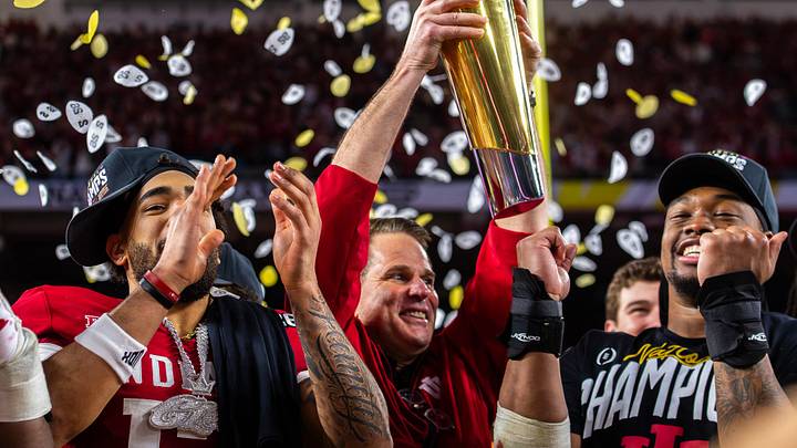 Indiana Head Coach Curt Cignetti lifts the trophy on the podium after the College Football Playoff National Championship college football game at Hard Rock Stadium in Miami Gardens. Indiana Head Coach Curt Cignetti lifts the trophy on the podium after the College Football Playoff National Championship college football game at Hard Rock Stadium in Miami Gardens.