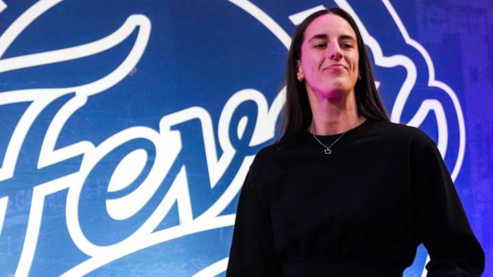 Indiana Fever guard Caitlin Clark (22) walks past the photo backdrop Wednesday, Aug. 28, 2024, during a game between the Indiana Fever and the Connecticut Sun at Gainbridge Fieldhouse in Indianapolis. Indiana Fever guard Caitlin Clark (22) walks past the photo backdrop Wednesday, Aug. 28, 2024, during a game between the Indiana Fever and the Connecticut Sun at Gainbridge Fieldhouse in Indianapolis.