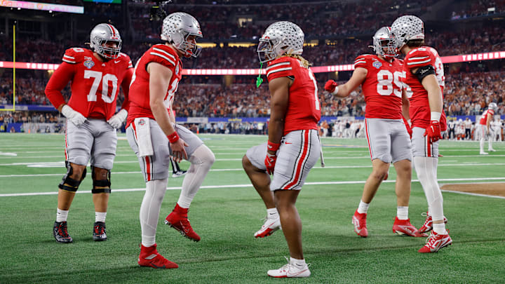 Will Howard #18 and Quinshon Judkins #1 of the Ohio State Buckeyes celebrate a touchdown against the Texas Longhorns during the Goodyear Cotton Bowl at AT&T Stadium on January 10, 2025 in Arlington, Texas.