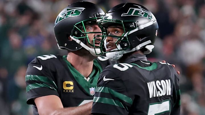 Oct 31, 2024; East Rutherford, New Jersey, USA; New York Jets quarterback Aaron Rodgers (8) and wide receiver Garrett Wilson (5) watch a video replay of their touchdown against the Houston Texans during the fourth quarter at MetLife Stadium. Mandatory Credit: Brad Penner-Imagn Images