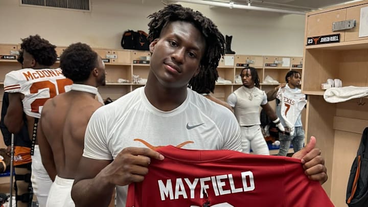 Texas Longhorns linebacker Anthony Hill Jr. holds up Baker Mayfield's jersey after a 34-3 win over the Oklahoma Sooners in Dallas.