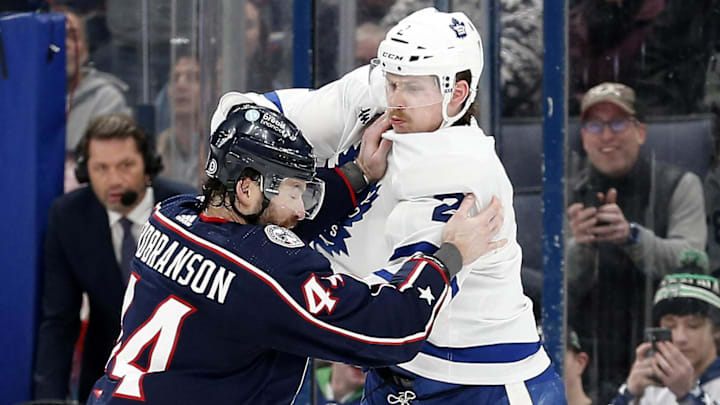 Dec 29, 2023; Columbus, Ohio, USA; Columbus Blue Jackets defenseman Erik Gudbranson (44) and Toronto Maple Leafs defenseman Simon Benoit (2) fight during the second period at Nationwide Arena. Mandatory Credit: Russell LaBounty-Imagn Images