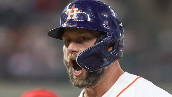 Christian Walker shouts after a hit in a blue Astros helme