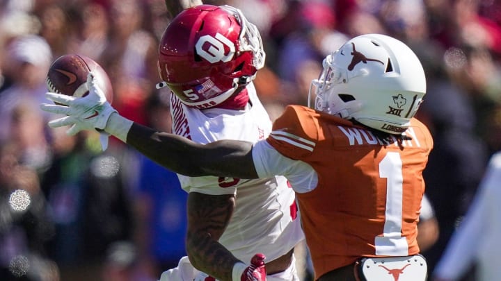 Texas Longhorns wide receiver Xavier Worthy (1) drops the ball against Oklahoma Sooners defensive back Woodi Washington (5) defends on the play in the fourth quarter during an NCAA college football game at the Cotton Bowl on Saturday, Oct. 7, 2023 in Dallas, Texas. This game makes up the 119th rivalry match up.
