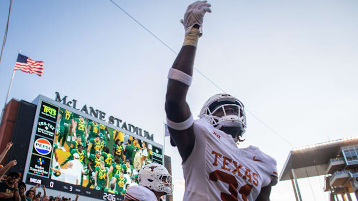 Texas defensive end Billy Walton III (31) gestures at the crowd of Texas fans as the team runs out