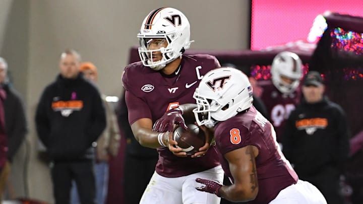 Oct 24, 2025; Blacksburg, Virginia, USA;  Virginia Tech Hokies quarterback Kyron Drones (1) hands the ball off to running back Terion Stewart (8) against the California Golden Bears during the first quarter at Lane Stadium. Mandatory Credit: Brian Bishop-Imagn Images