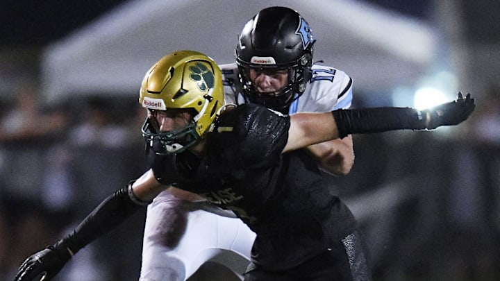 Ponte Vedra Sharks Caleb Stanton (12) tries to control Nease Panthers Jacob Curry (1) during late third quarter action. The Nease Panthers hosted the Ponte Vedra Sharks in High School Football Friday evening, August 23, 2024. The Panthers were the 24 to 7 victors over the Sharks.