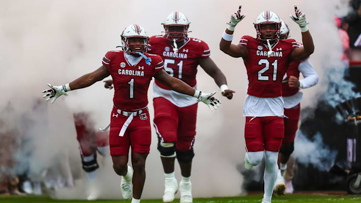 Nov 11, 2023; Columbia, South Carolina, USA; South Carolina Gamecocks defensive back DQ Smith (1), offensive lineman Tree Babalade (51), and defensive back Nick Emmanwori (21) lead their teammates onto the field before a game against the Vanderbilt Commodores at Williams-Brice Stadium. Mandatory Credit: Jeff Blake-Imagn Images