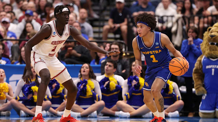 Mar 20, 2026; Tampa, FL, USA; Hofstra Pride guard Preston Edmead (1) dribbles against Alabama Crimson Tide forward Taylor Bol Bowen (7) in the second half during a first round game of the men's 2026 NCAA Tournament at Benchmark International Arena. 