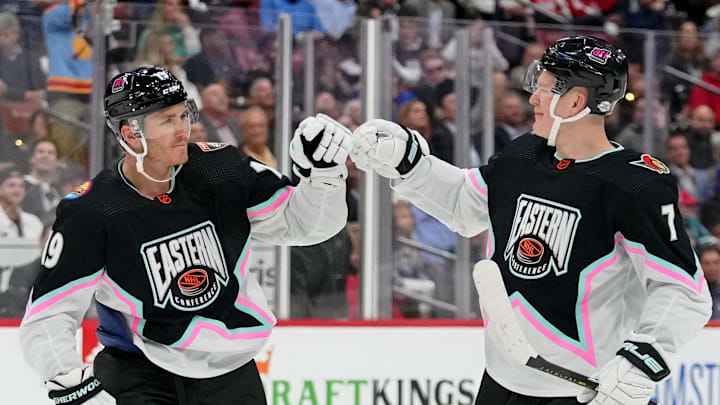 Feb 4, 2023; Sunrise, Florida, USA; Atlantic Division forward Matthew Tkachuk (19) of the Florida Panthers fist bumps Atlantic Division forward Brady Tkachuk (71) of the Ottawa Senators during the second period of a semifinal game during the 2023 NHL All-Star Game at FLA Live Arena. Mandatory Credit: Jasen Vinlove-Imagn Images