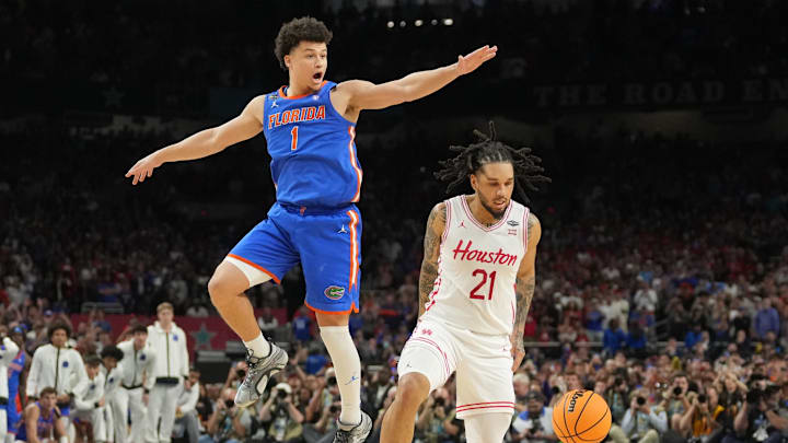 Apr 7, 2025; San Antonio, TX, USA; Houston Cougars guard Emanuel Sharp (21) loses the ball as he attempts to shoot against Florida Gators guard Walter Clayton Jr. (1)  in the second half in the national championship game of the Final Four of the 2025 NCAA Tournament at the Alamodome. Mandatory Credit: Robert Deutsch-Imagn Images