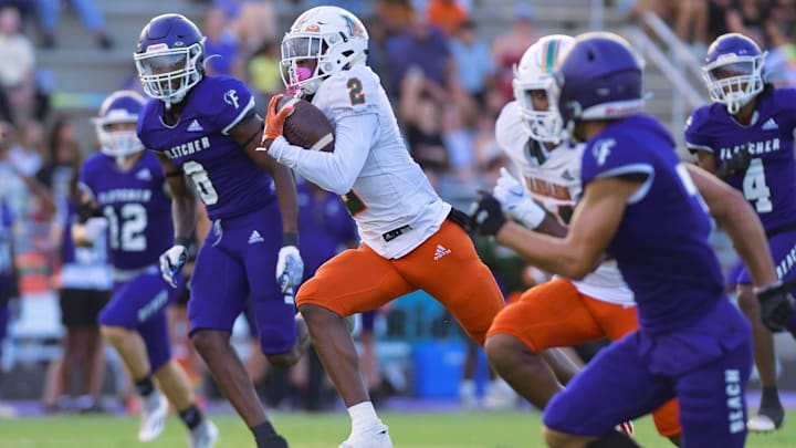 Mandarin's Jaime Ffrench outruns Fletcher defenders as he takes a pass for a 65 yard touchdown in