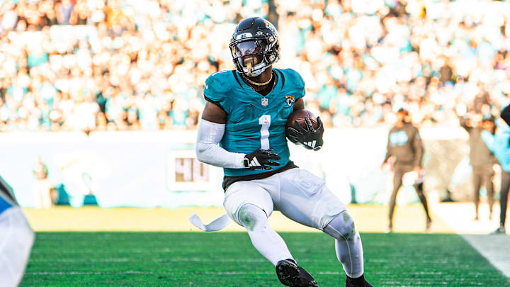Dec 31, 2023; Jacksonville, Florida, USA; Jacksonville Jaguars running back Travis Etienne Jr. (1) runs the ball against Carolina at EverBank Stadium. Mandatory Credit: Jeremy Reper-USA TODAY Sports