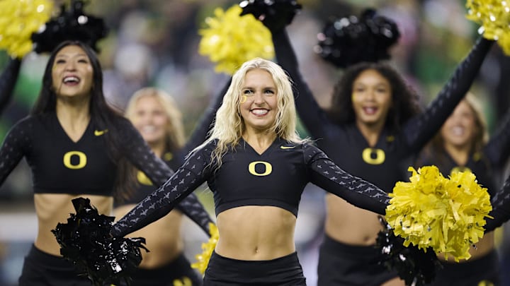 Nov 30, 2024; Eugene, Oregon, USA; The Oregon Ducks cheer team perform during a time out during the second half of a game against the Washington Huskies at Autzen Stadium. Mandatory Credit: Troy Wayrynen-Imagn Images