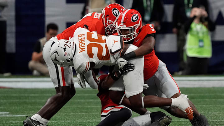 Georgia linebacker CJ Allen (3) takes down Texas running back Quintrevion Wisner (26) during the first half of the SEC championship game against Texas in Atlanta, on Saturday, Dec. 7, 2024.