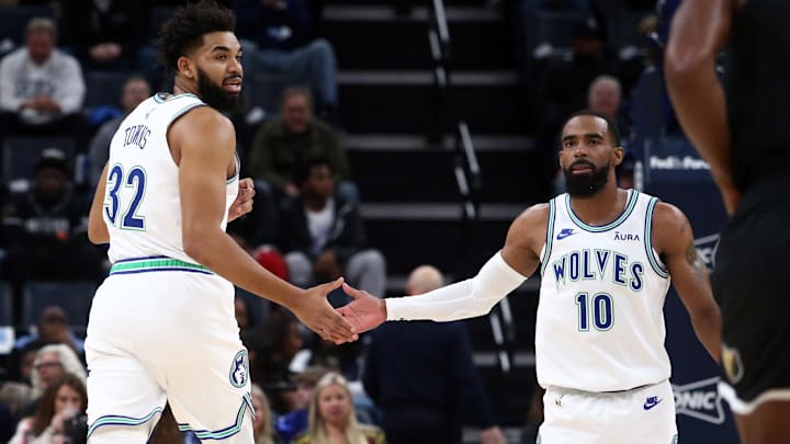Dec 8, 2023; Memphis, Tennessee, USA; Minnesota Timberwolves center-forward Karl-Anthony Towns (32) reacts with guard Mike Conley (10) during the first half against the Memphis Grizzlies  at FedExForum. Mandatory Credit: Petre Thomas-Imagn Images