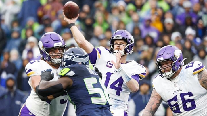 Dec 22, 2024; Seattle, Washington, USA; Minnesota Vikings quarterback Sam Darnold (14) throws a touchdown pass against the Seattle Seahawks during the second quarter at Lumen Field. Mandatory Credit: Joe Nicholson-Imagn Images