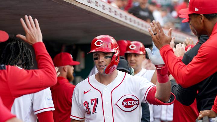 Cincinnati Reds catcher Tyler Stephenson (37) is embraced by teammates as he returns to the dugout after hitting a home run in the first inning of a MLB game between the Cincinnati Reds and Washington Nationals, Wednesday, May 13, 2026, at Great American Ball Park in downtown Cincinnati.