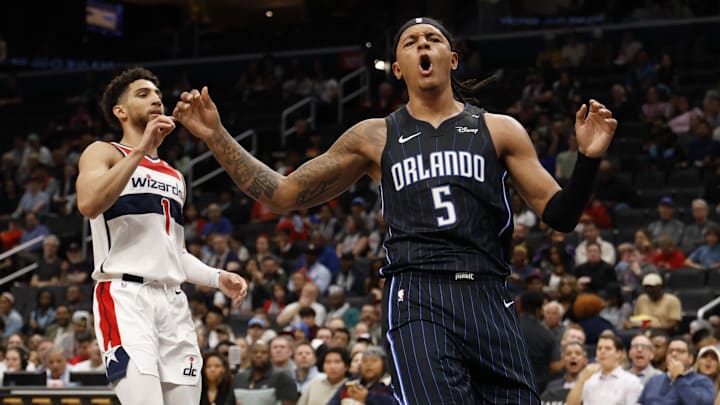 Apr 3, 2025; Washington, District of Columbia, USA; Orlando Magic forward Paolo Banchero (5) celebrates after dunking the ball as Washington Wizards guard Colby Jones (1) looks on in the first half at Capital One Arena. Mandatory Credit: Geoff Burke-Imagn Images