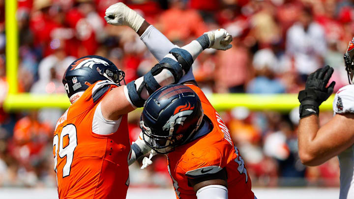September 22, 2024, Tampa, Florida, USA: Denver Broncos defensive end Zach Allen (99) and defensive tackle Malcolm Roach (97) celebrate, after they sack Tampa Bay Buccaneers quarterback Baker Mayfield (6) during the fourth quarter at Raymond James Stadium in Tampa on Sunday, Sept. 22, 2024. 