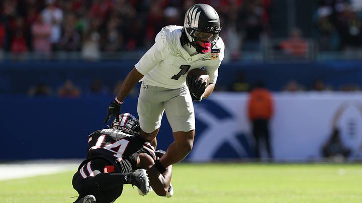 Jan 1, 2026; Miami Gardens, FL, USA; Oregon Ducks wide receiver Dakorien Moore (1) is tackled by Texas Tech Red Raiders defensive back Brice Pollock (14) during the first half of the 2025 Orange Bowl and quarterfinal game of the College Football Playoff at Hard Rock Stadium. Mandatory Credit: Nathan Ray Seebeck-Imagn Images