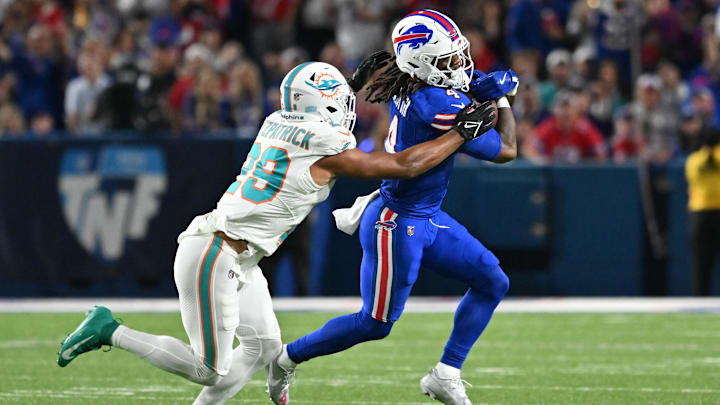 Buffalo Bills running back James Cook (4) runs against Miami Dolphins free safety Minkah Fitzpatrick (29) in the first quarter at Highmark Stadium.