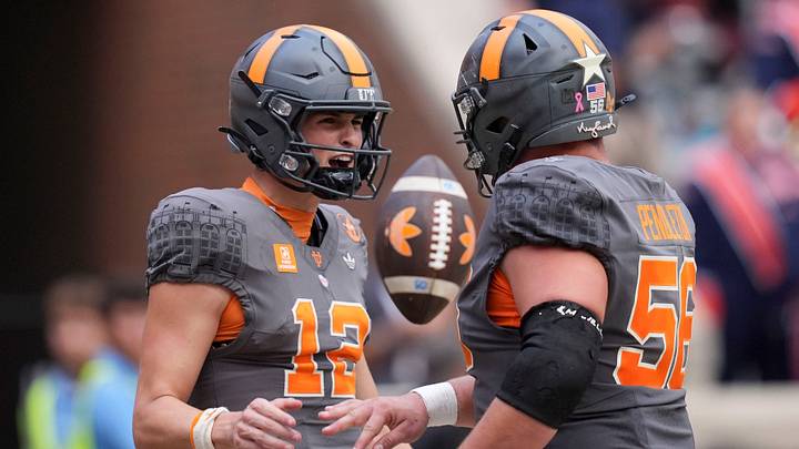Tennessee quarterback George MacIntyre (12) and offensive lineman Sam Pendleton (56) celebrate after a play during a college football game against Auburn on Oct. 3, 2026, in Knoxville, Tennessee.
