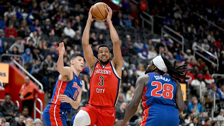 Mar 23, 2025; Detroit, Michigan, USA; New Orleans Pelicans guard CJ McCollum (3) drives to the basket against Detroit Pistons center Isaiah Stewart (28) and forward Simone Fontecchio (19)  in the first quarter at Little Caesars Arena. Mandatory Credit: Lon Horwedel-Imagn Images