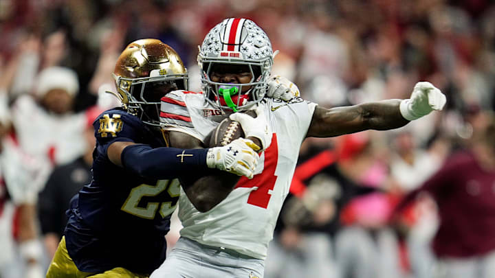 Ohio State Buckeyes wide receiver Jeremiah Smith (4) makes a catch against Notre Dame Fighting Irish cornerback Christian Gray (29) in the fourth quarter during the College Football Playoff National Championship at Mercedes-Benz Stadium in Atlanta on January 20, 2025.