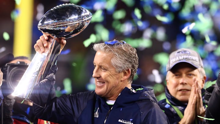 Feb 2, 2014; East Rutherford, NJ, USA; Seattle Seahawks head coach Pete Carroll hoists the Vince Lombardi Trophy after Super Bowl XLVIII against the Denver Broncos at MetLife Stadium.