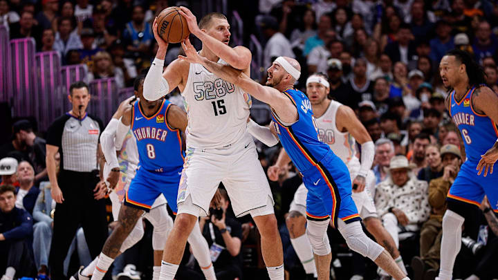 May 15, 2025; Denver, Colorado, USA; Denver Nuggets center Nikola Jokic (15) controls the ball under pressure form Oklahoma City Thunder guard Alex Caruso (9) in the second quarter during game six of the second round for the 2025 NBA Playoffs at Ball Arena. Mandatory Credit: Isaiah J. Downing-Imagn Images