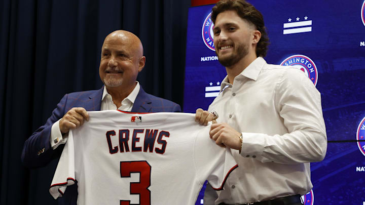 Jul 22, 2023; Washington, District of Columbia, USA; Washington Nationals president of baseball operations and general manager Mike Rizzo (L) and Nationals first round draft pick outfielder Dylan Crews (R) hold Crews' jersey at an introductory press conference prior to the Nationals' game against the San Francisco Giants at Nationals Park.