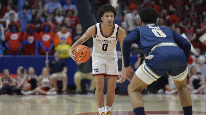 Dayton Flyers guard Javon Bennett dribbles the ball against George Washington guard Trey Autry.