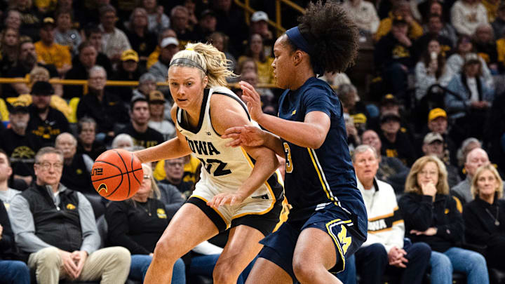 Iowa guard Callie Levin (32) dribbles against Michigan guard Mila Holloway (3) Feb. 22, 2026 at Carver-Hawkeye Arena in Iowa City, Iowa.