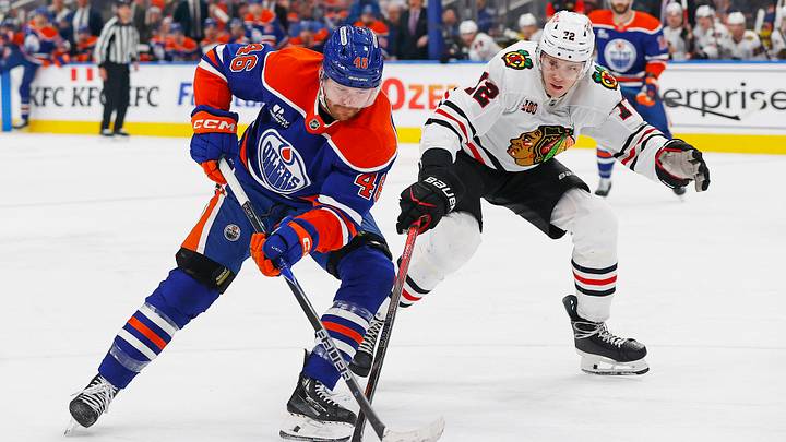 Apr 2, 2026; Edmonton, Alberta, CAN; Edmonton Oilers forward Max Jones (46) carries the puck around Chicago Blackhawks defensemen Alex Vlasic (72) during the third period at Rogers Place. Mandatory Credit: Perry Nelson-Imagn Images